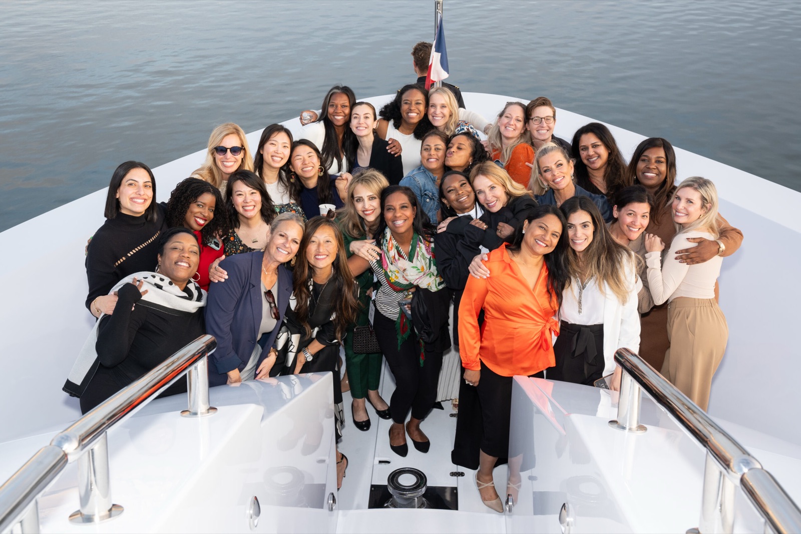Guiding Leaders participants gathered on the bow of a yacht